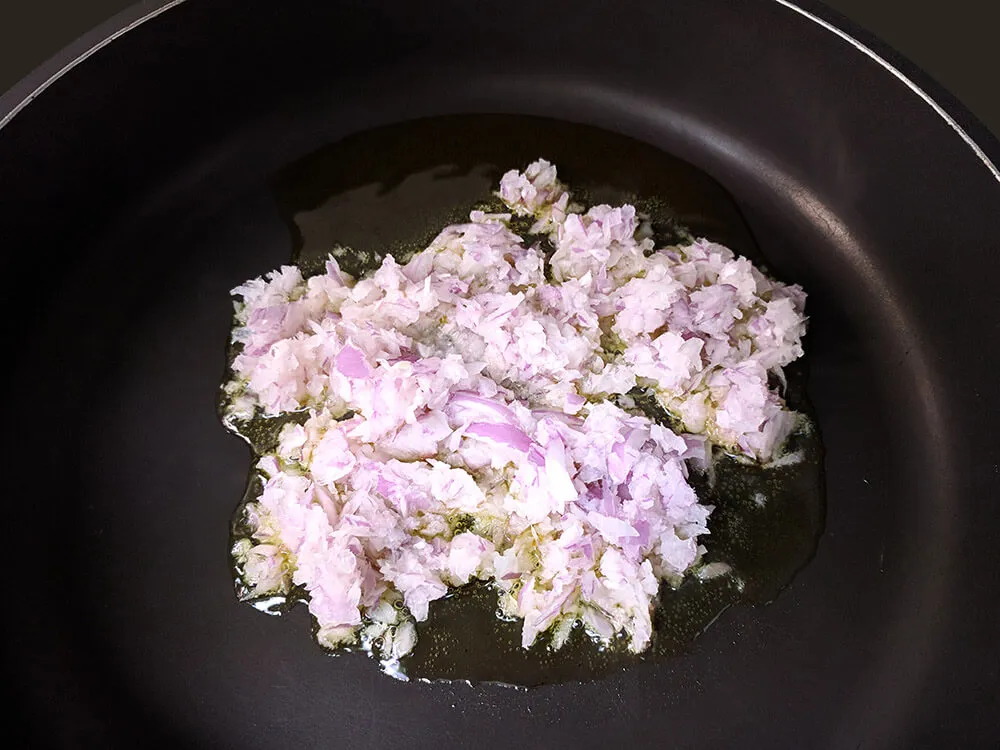 Cebolla picada pochando en sartén.