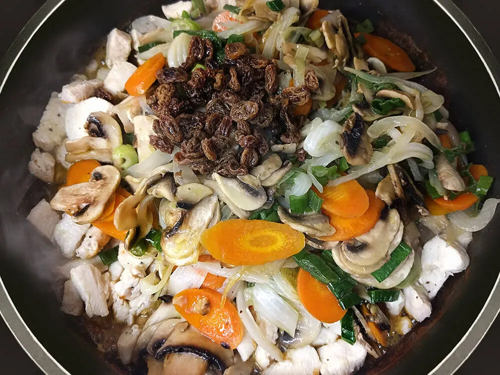 Tiras de pollo, hortalizas y uvas pasas