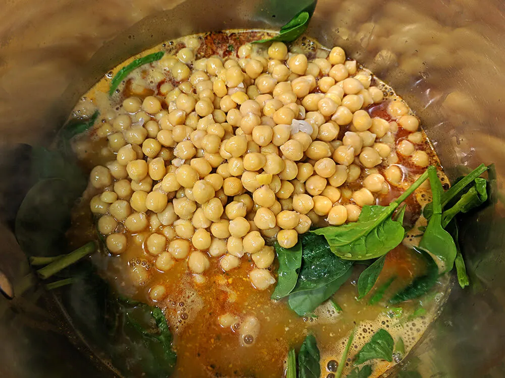 Caldo de pescado, garbanzos y espinacas baby.