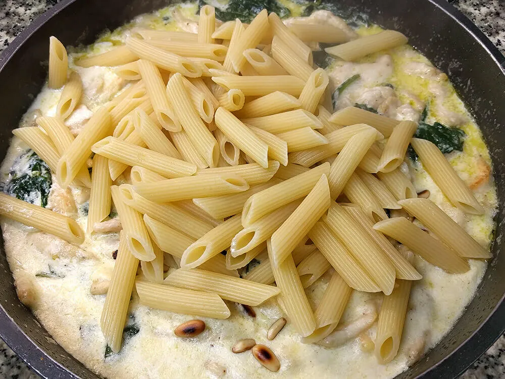 Pasta hervida con pollo rehogado con espinacas y crema de leche